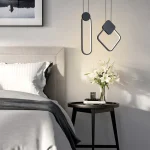 Lampe de chevet suspendue LED nordique au‑dessus d’une table de nuit dans une chambre modern